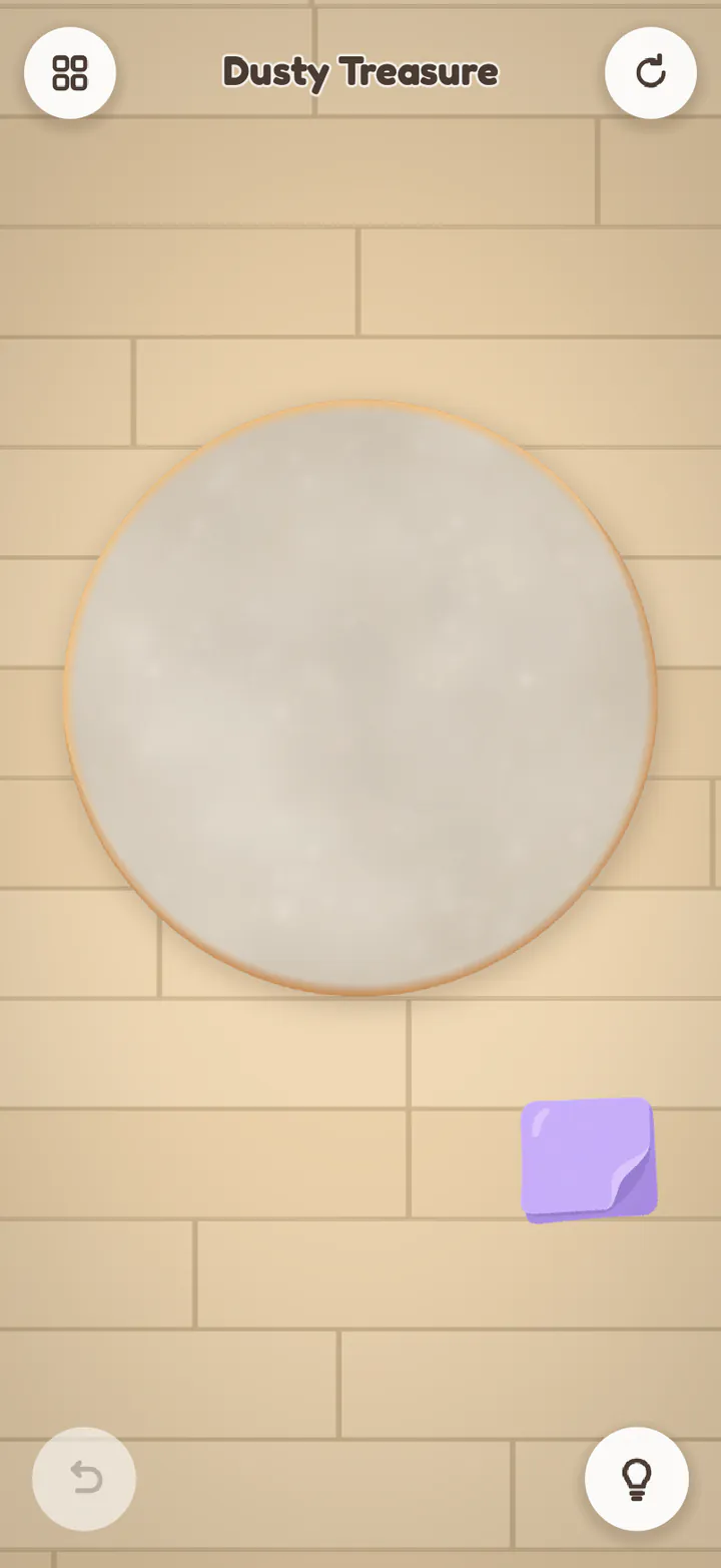Dusty Treasure as it starts: a round frame hidden under grey dust, and a cloth to rub it with.